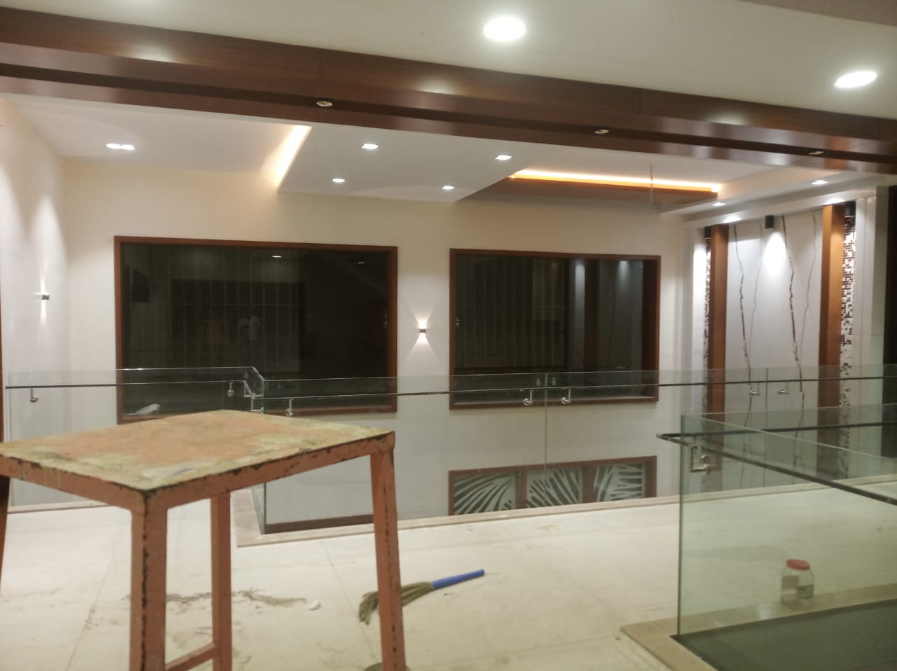 Double height mezzanine hallway with glass railing